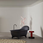 Grey armchair style bathtub featuring modern slipper shape and comfortable deep soaking design