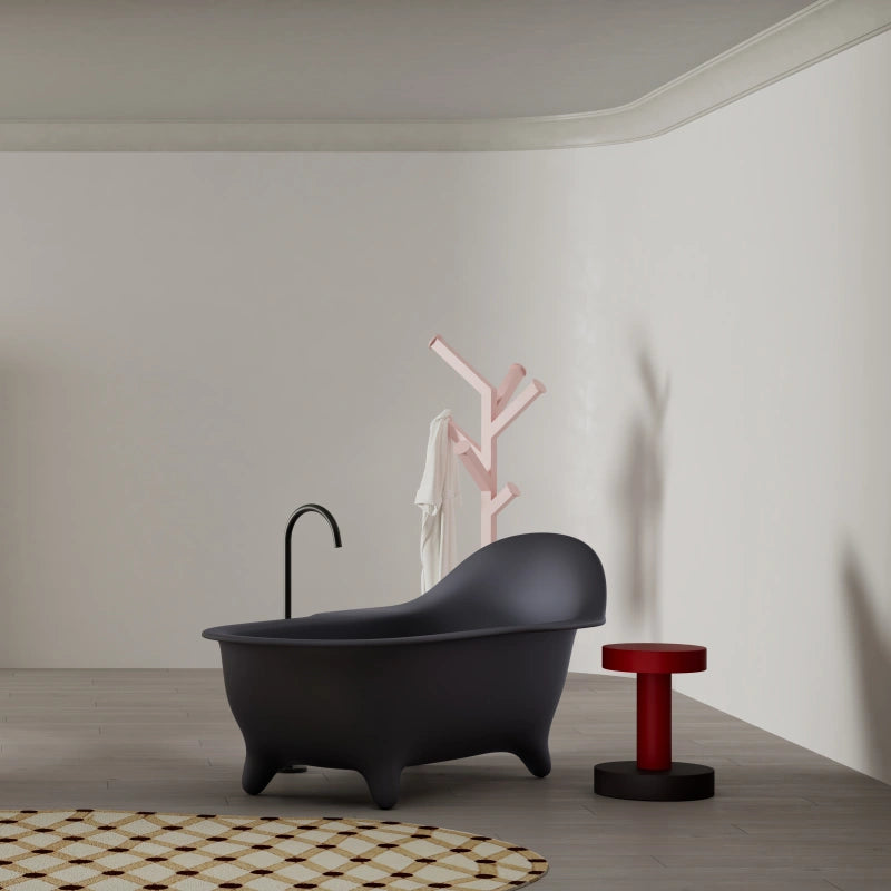 Grey armchair style bathtub featuring modern slipper shape and comfortable deep soaking design