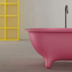 Contemporary pink freestanding bathtub with sculptural silhouette for spa inspired bathroom