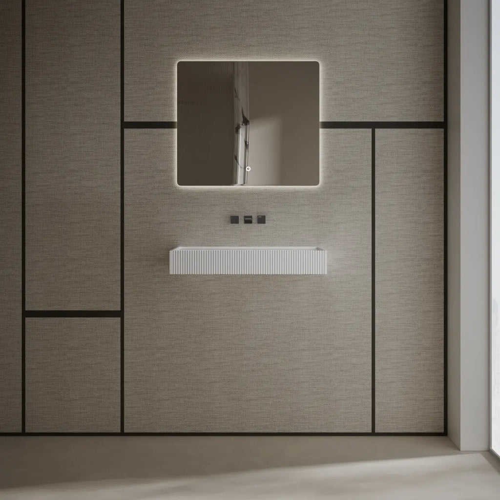 Modern white wall-hung wash basin featuring a spacious rectangular design and seamless finish