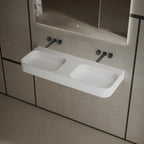 Modern white wall-hung double wash basin featuring a spacious rectangular design and seamless finish