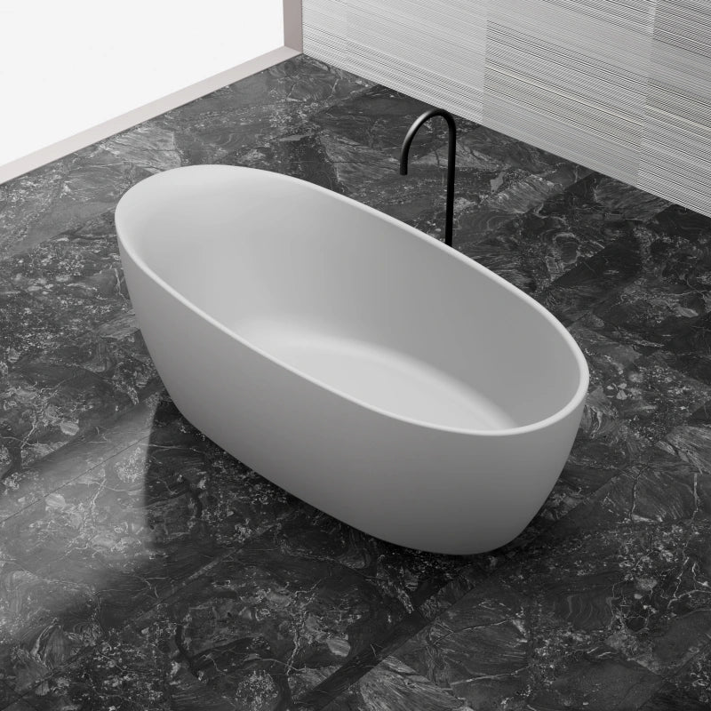 White solid surface oval freestanding bathtub side top view close-up