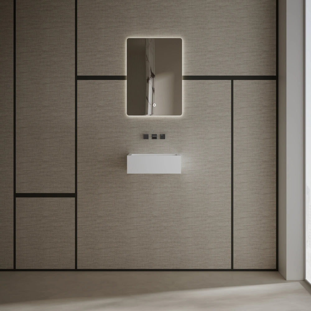 Matte white wall mounted wash basin installed in a modern luxury bathroom setting