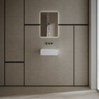 Matte white wall mounted wash basin installed in a modern luxury bathroom setting